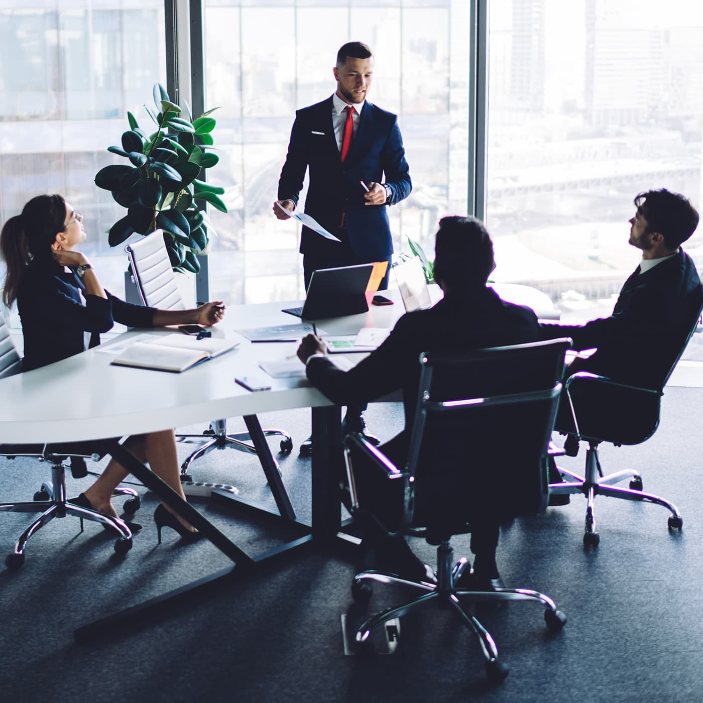 A team of consultants in a conference meeting room discussing fleet utilisation strategies. A team of consultants in a conference meeting room discussing fleet utilisation strategies.