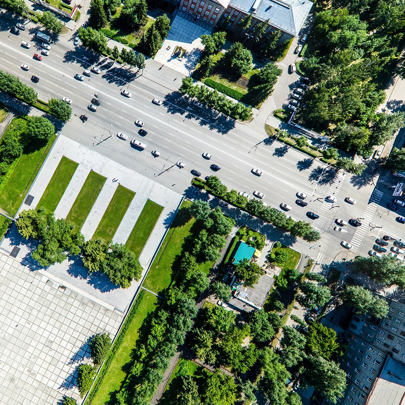 Aerial city view with crossroads, roads, houses, buildings, parks and parking lots. Aerial city view with crossroads, roads, houses, buildings, parks and parking lots.