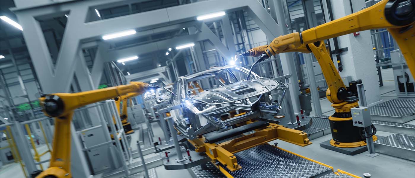 Robotic arms assembling car frames in a factory. Robotic arms assembling car frames in a factory.