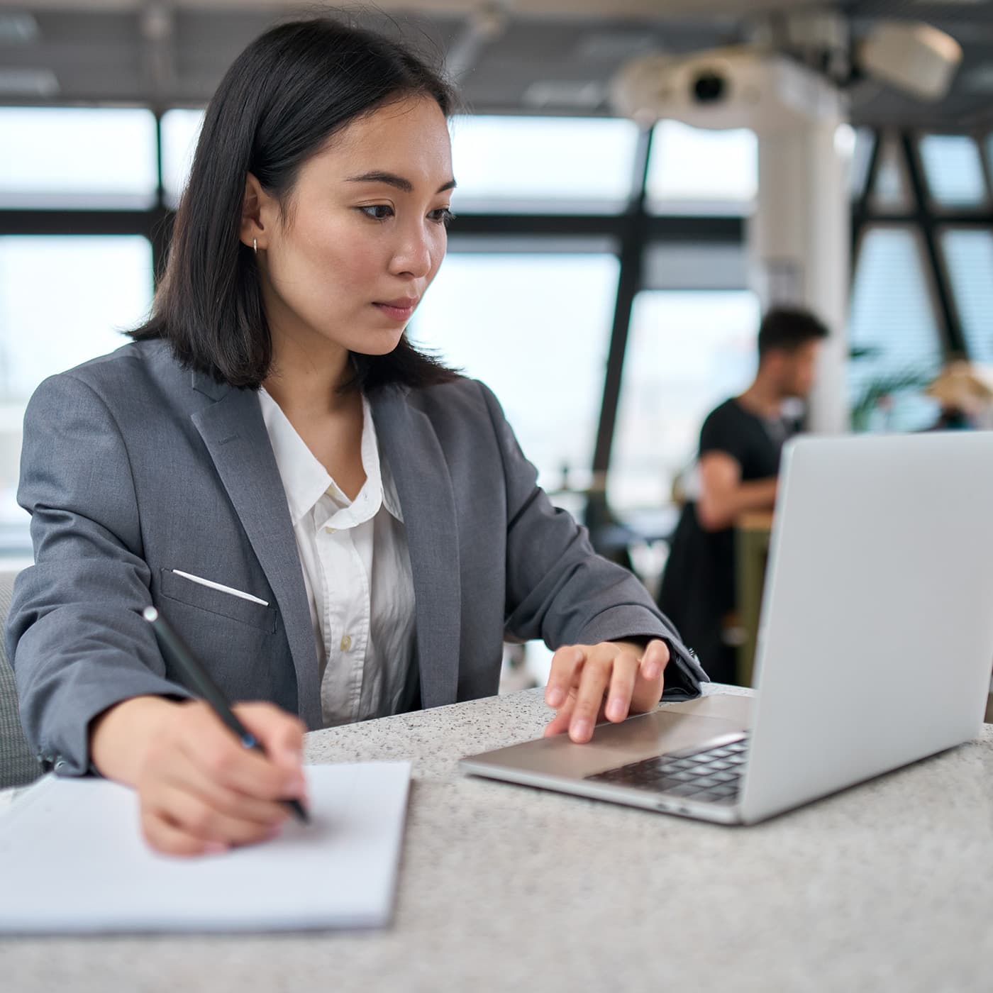 Young female fleet manager using her laptop to access Fleet Office to access reporting on her organisation's fleet operation. Young female fleet manager using her laptop to access Fleet Office to access reporting on her organisation's fleet operation.