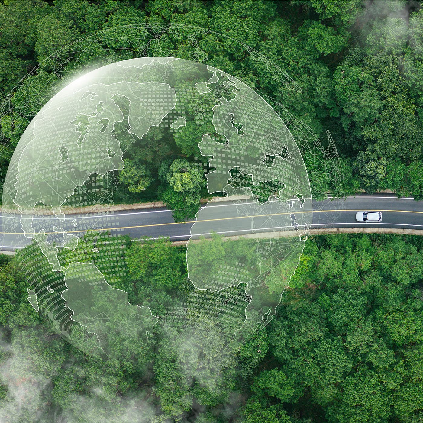 Aerial view of an electric car on a road midst forest and natural pverlaid with a digital image of planet earth. Aerial view of an electric car on a road midst forest and natural pverlaid with a digital image of planet earth.