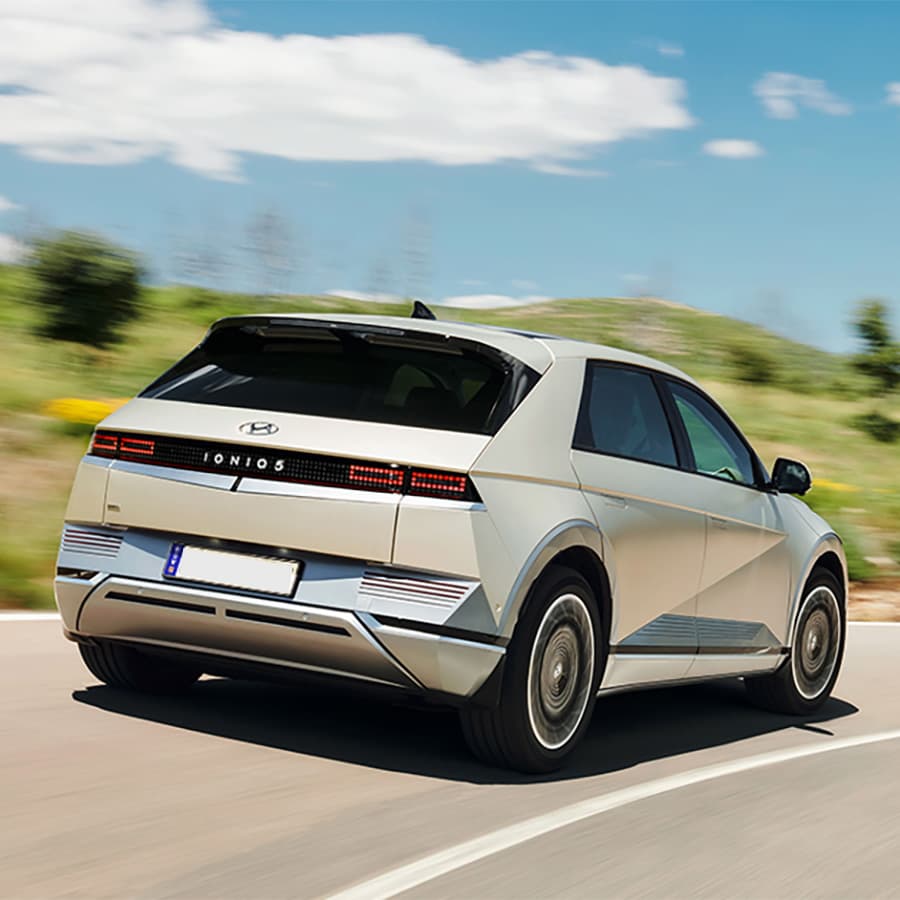 A rear view of the Hyundai Iconiq 5 driving on a road. A rear view of the Hyundai Iconiq 5 driving on a road.