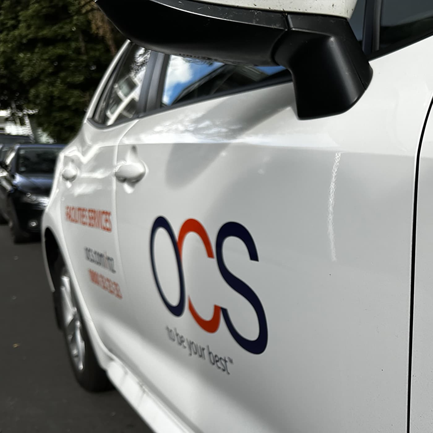 The hero image shows a close up of the side of a white hybrid PHEV vehicle, with the OCS be your best logo. The hero image shows a close up of the side of a white hybrid PHEV vehicle, with the OCS be your best logo.