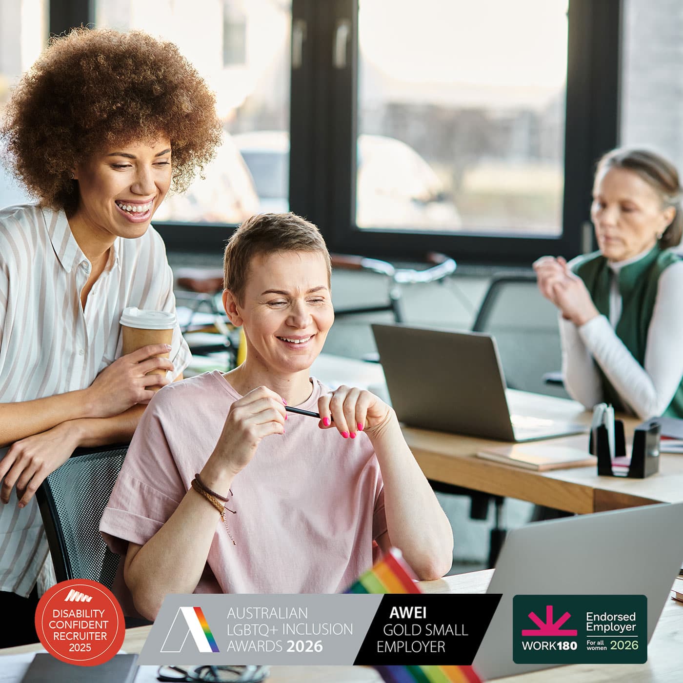 A diverse group of women in the workplace, smiling. A diverse group of women in the workplace, smiling.