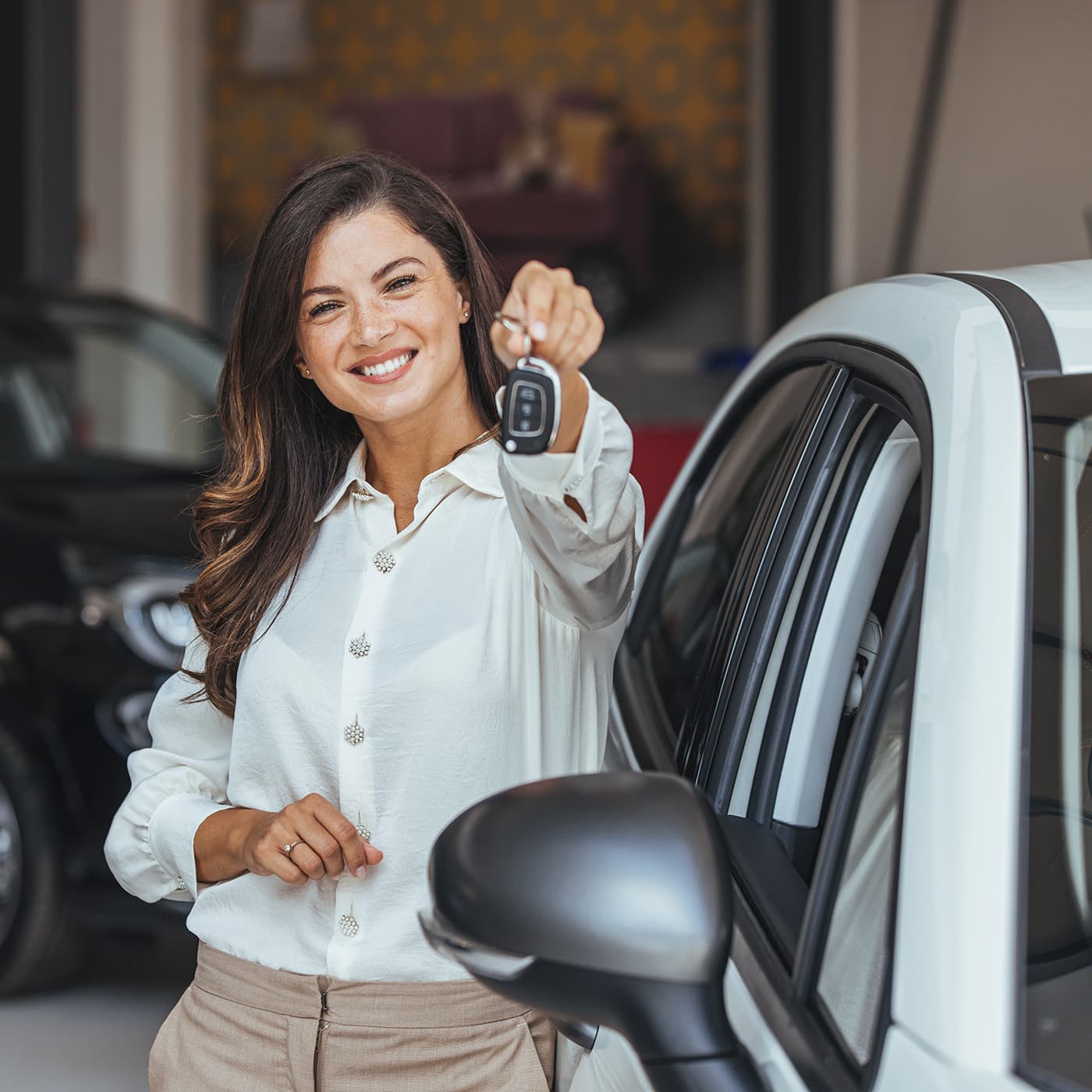 Young woman holding car keys after purchasing her car. Young woman holding car keys after purchasing her car.