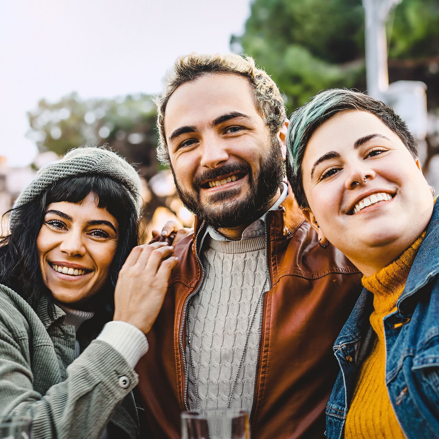 A group of diverse co-workers smiling and hugging. A group of diverse co-workers smiling and hugging.