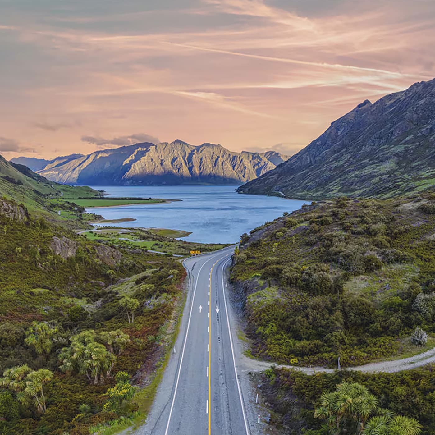 The hero image shows a photo of New Zealand green mountains and hills. The hero image shows a photo of New Zealand green mountains and hills.