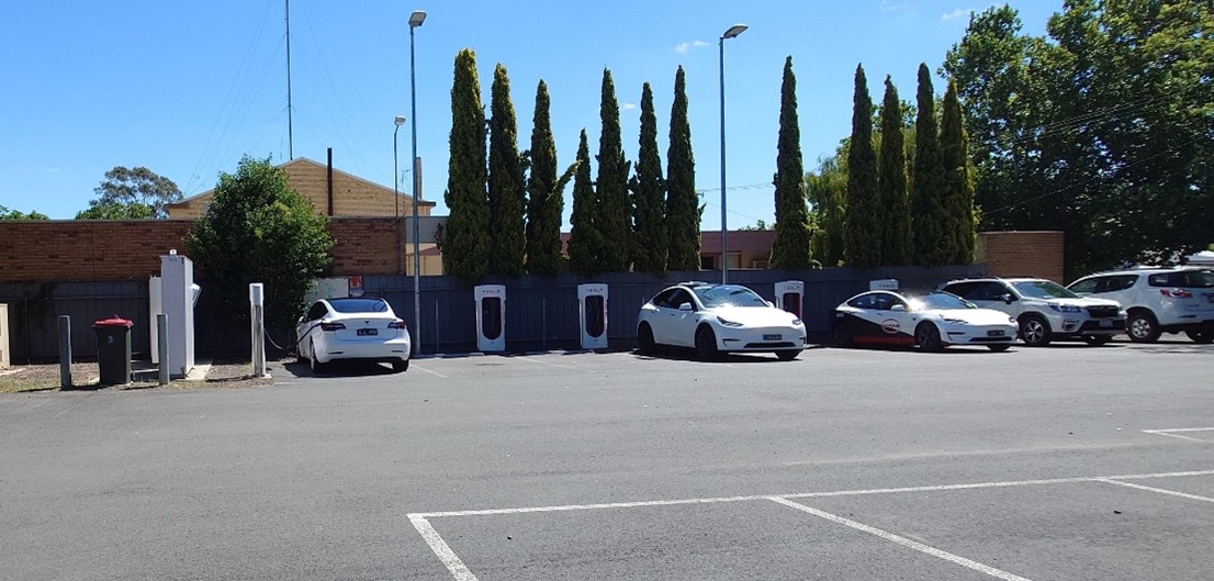 Many EV vehicles lined up at charging station